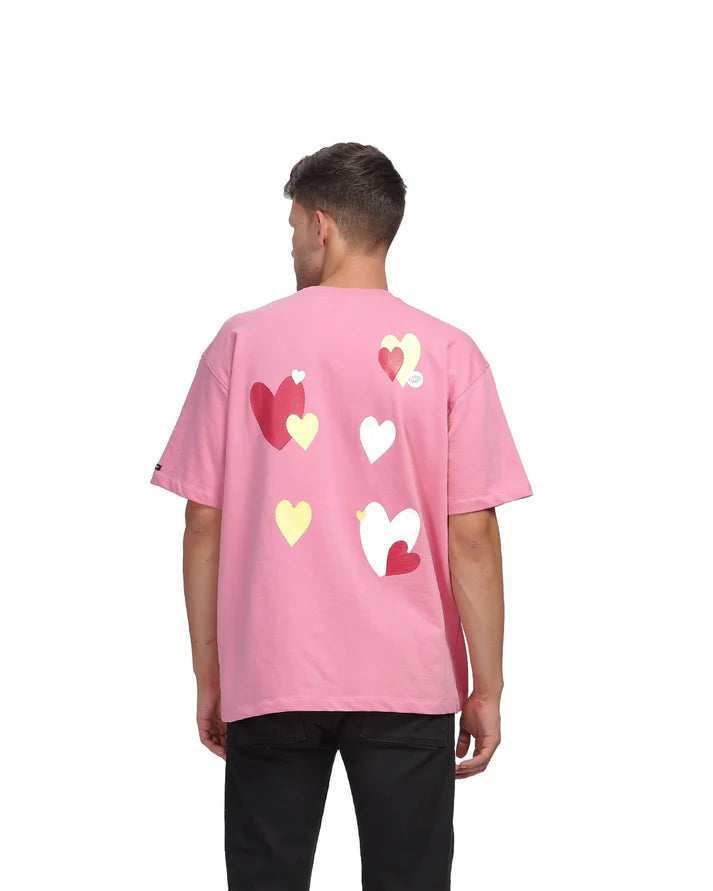 This Love & Kisses Oversized Tee is a 240GSM cotton oversized tee featuring a textured heart and screen-printed details for added visual interest, available at Cop Underdog In-store and ready to ship.